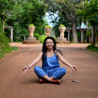 Woman meditating in nature - wellness and mindfulness for better health
